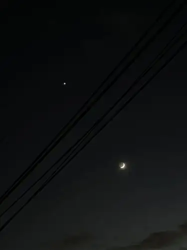 Celestial beauty meets urban lines.